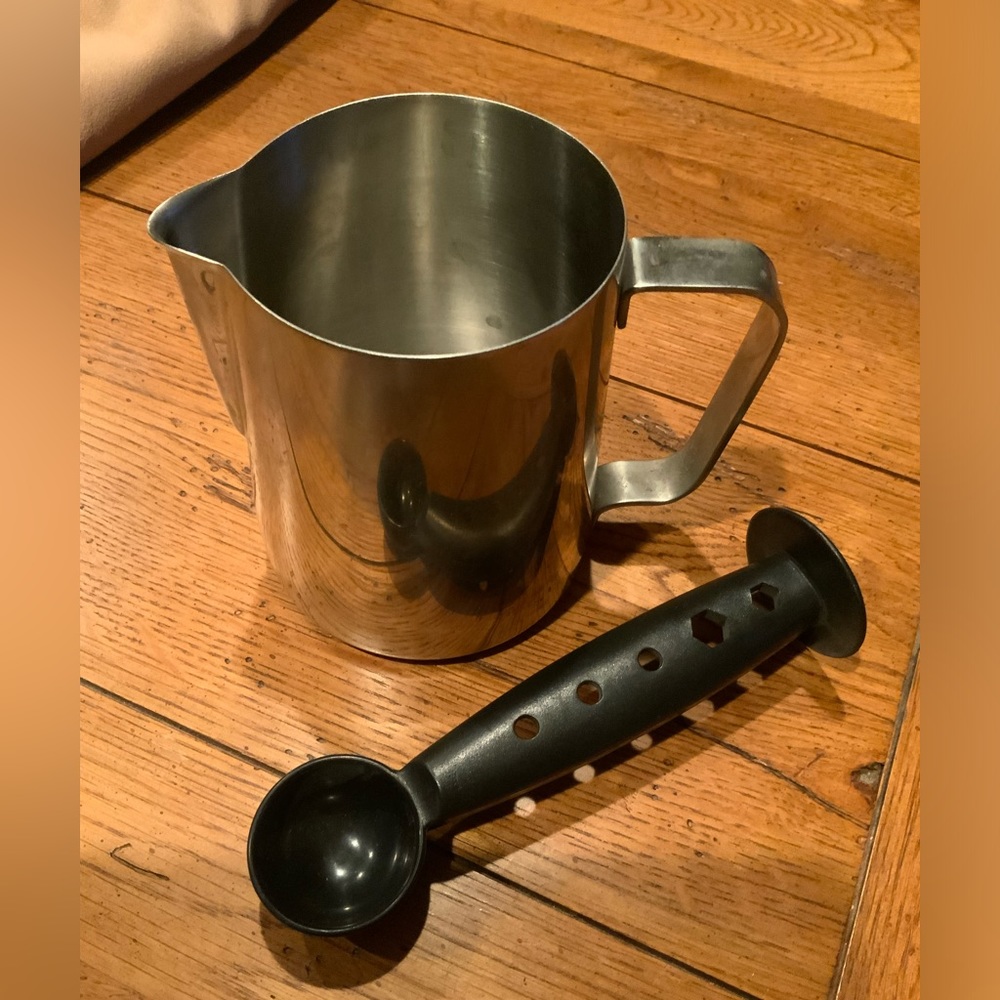 Milk frothing cup with measure and pack plastic spoon.